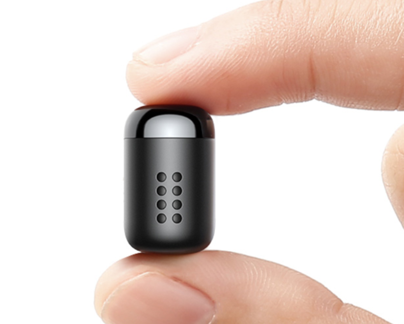 Compact ScentFrame air freshener held between fingers showing small size